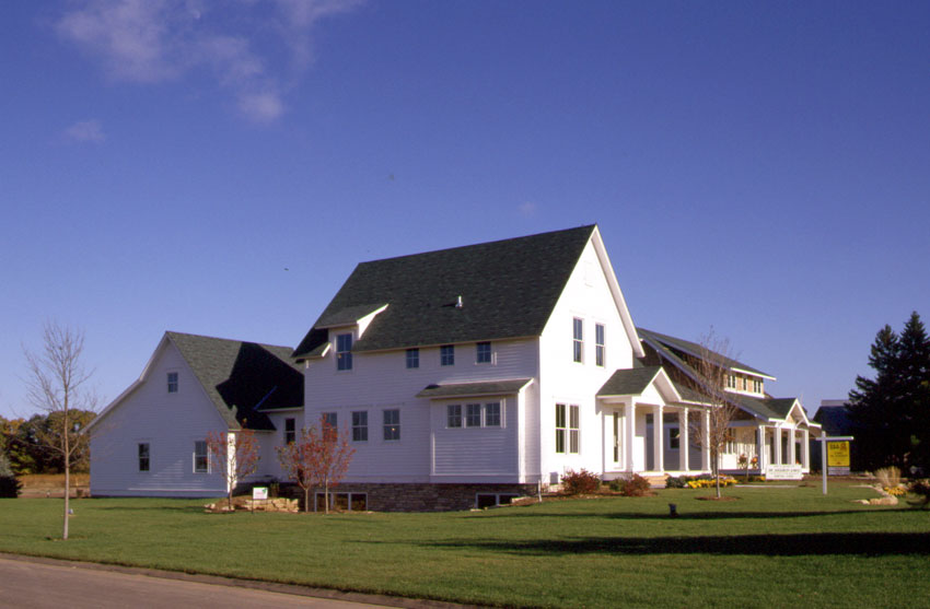 Prairie Farmhouse: Exterior from the side showing mudroom and attached garage